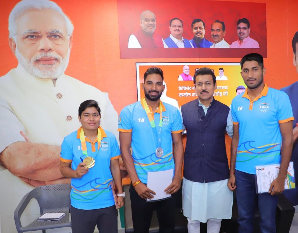 Col. Rajyavardhan Rathore interacting with young athletes and providing sports kits.