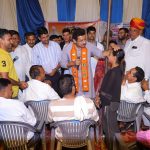 Col. Rajyavardhan Rathore actively addressing local citizens and coordinating with state officers at a grassroots public meet.