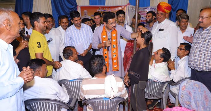 Col. Rajyavardhan Rathore actively addressing local citizens and coordinating with state officers at a grassroots public meet.