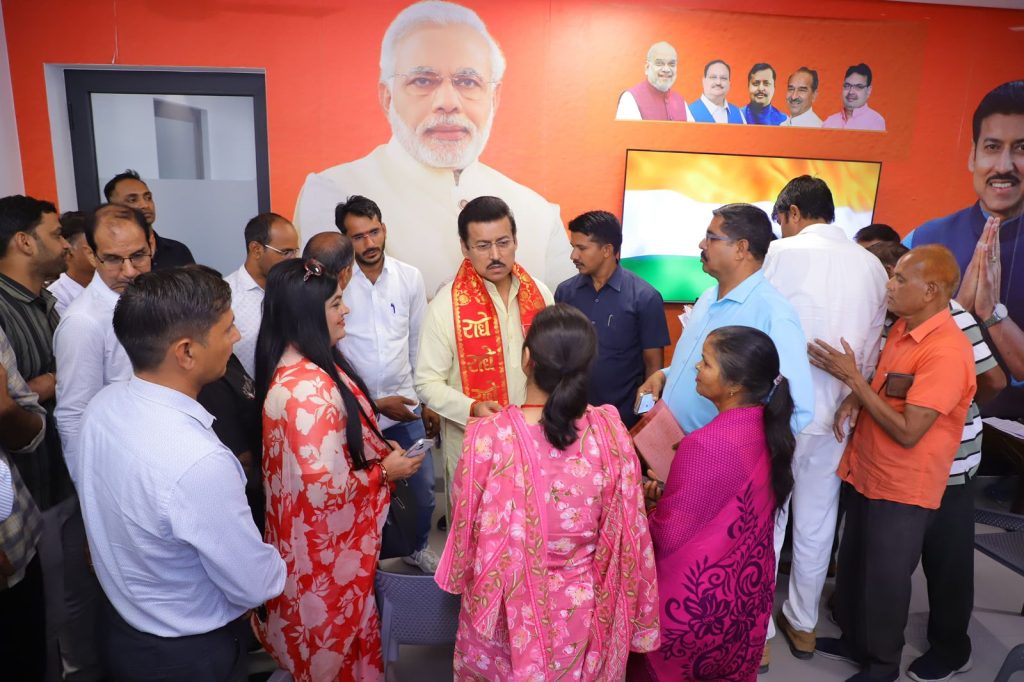Col. Rajyavardhan Rathore listening intently to rural residents during an open-air Jan-Samvad session in a local village.