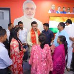 Col. Rajyavardhan Rathore listening intently to rural residents during an open-air Jan-Samvad session in a local village.