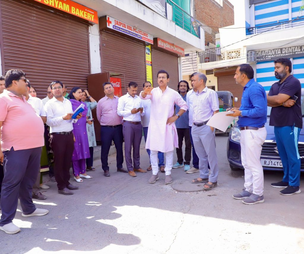 Col. Rajyavardhan Rathore interacting with local morning residents and reviewing a civic infrastructure site in Jhotwara at 7:30 AM.
