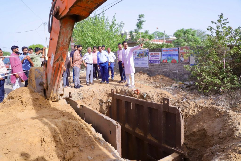 Col. Rajyavardhan Rathore inspecting a local library construction site and interacting with ward residents during a development review.