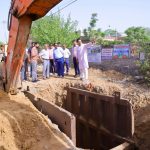 Col. Rajyavardhan Rathore inspecting a local library construction site and interacting with ward residents during a development review.
