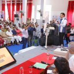 Sports Minister Col. Rajyavardhan Rathore interacting with young rural athletes on a newly upgraded village sports ground during a talent review.