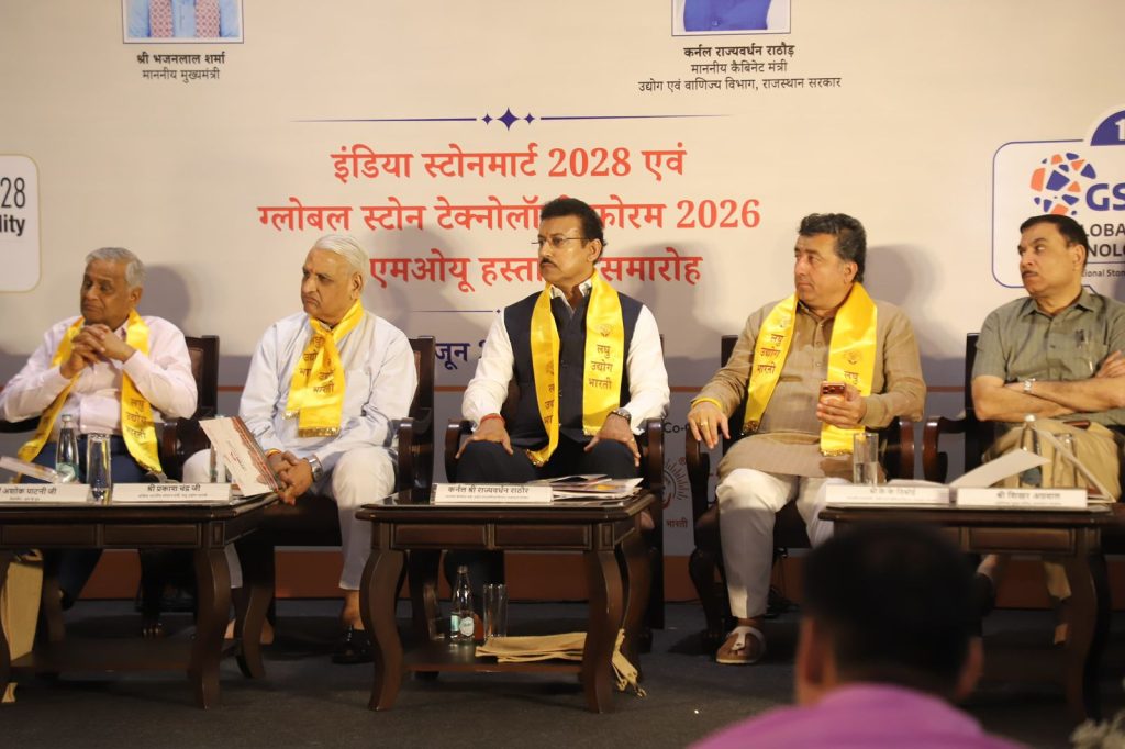 Rajasthan Industry Minister Col. Rajyavardhan Singh Rathore interacting with international delegates and tech startup founders at the India Stone Mart pavilion in Jaipur.