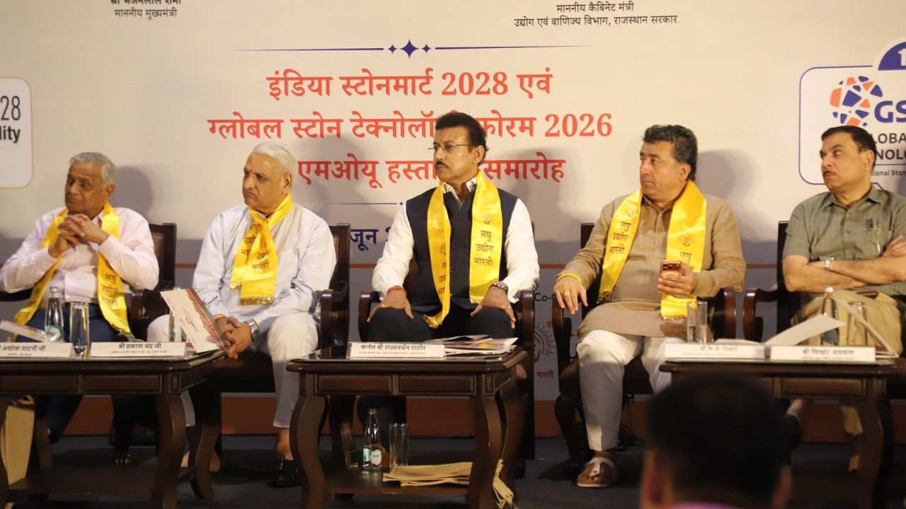 Rajasthan Industry Minister Col. Rajyavardhan Singh Rathore interacting with international delegates and tech startup founders at the India Stone Mart pavilion in Jaipur.